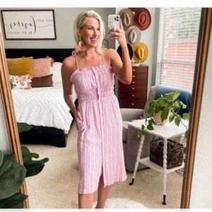 Universal thread sundress with spaghetti straps and button detailing.